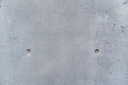 Smooth bare concrete wall with concrete form dimples. Concrete texture background close up view.の写真素材