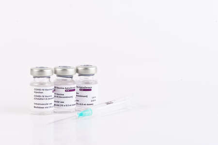San SebastiÃ¡n, Guipuzcoa Spain; February 02 2021: Covid-19 coronavirus AstraZeneca vaccine vials and syringe for vaccination of medical professionals and people at risk. White background. Copy space.のeditorial素材