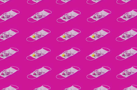 Repetition Pattern Of Medical Face Masks With Yellow Flowers And Yellow Background.  Protection Healthy Concept. Regular Pattern, Flat Lay.の写真素材