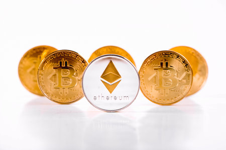 Crypto Currency Ethereum Coin Standing In Front Of Golden Bitcoins On White Background. Ethereum...