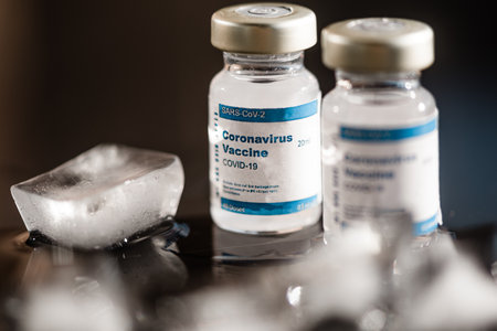 Bottles Of Sars-Cov-2 Coronavirus Vaccine With Melting Ice On Foreground. close up, studio shotのeditorial素材