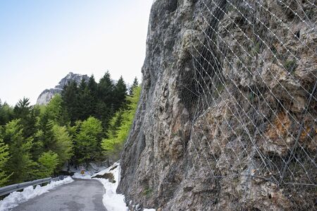 rockfall protection nets, installed to protect an rock wallの写真素材