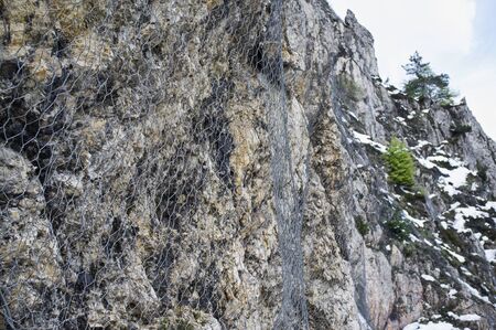 rockfall protection nets, installed to protect an rock wallの写真素材