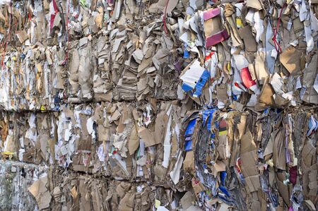 compressed paper and cardboard waiting recycling