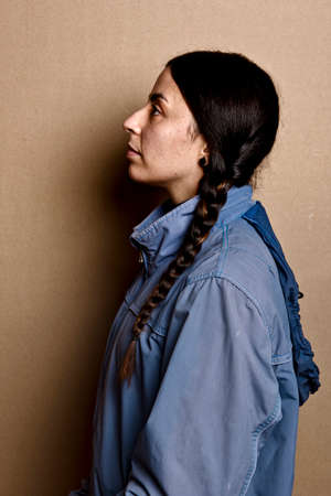 girl with blue jacket and without make up with the same hairstyle as Greta Thunberg, studio shot on...