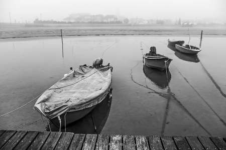 old fishing boats, on a foggy and cold winter dayの写真素材