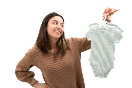 Young female with outstretched arms throw baby clothes in airの写真素材