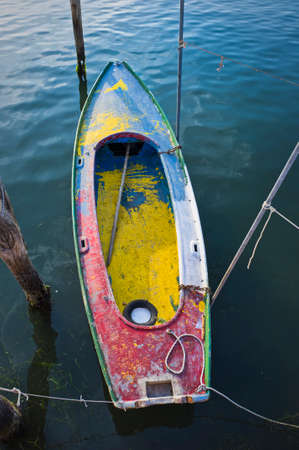 old wooden colored fishing boat anchored in the sea, calm natural landscapeの写真素材