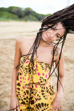 Portrait of girl in motion brown hair dreadlocks and trendy people conceptの写真素材