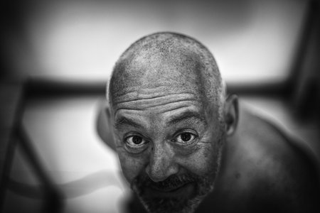 Man with a shaved head and a gazeの写真素材