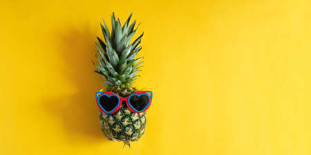 Pineapple hipster in sunglasses. Minimal concept, summer tropical pineapple. Summer, vacation, partyの写真素材