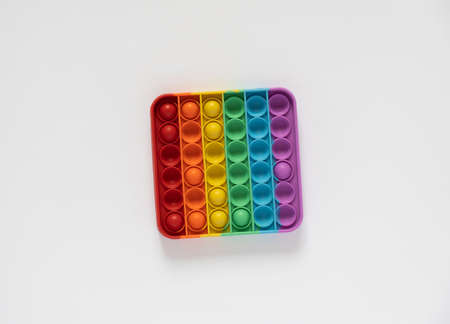 Colored toy antistress for kids pop it. Square with rainbow colors isolated on white background.