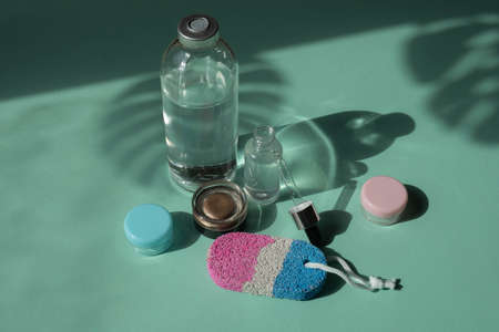 Body and spa treatments. Natural beauty products. Eco cream, serum, empty bottle for skin care. Glass pipette. Pumice stone for feet. Top view.の写真素材