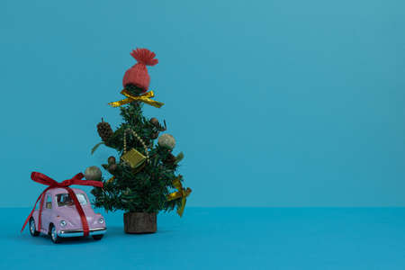 Pink typewriter gift under the Christmas tree. Merry Christmas. Happy New Year 2022の写真素材