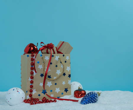 Paper bag with gifts standing on the snow.Winter concept. Merry Christmas.の写真素材