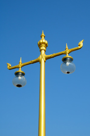 Electrical lamp pole in Thai design style with blue skyの写真素材