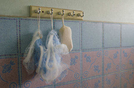 Soft body sponge hung on bar in bathroomの写真素材