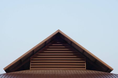 Roof top triangle from corrugated metal sheet against blank space areaの写真素材