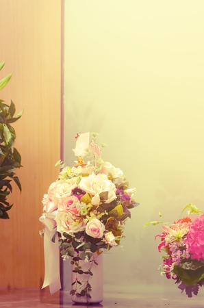 Beautiful bouquet of flowers in vase on the table with blur vintage filterの写真素材