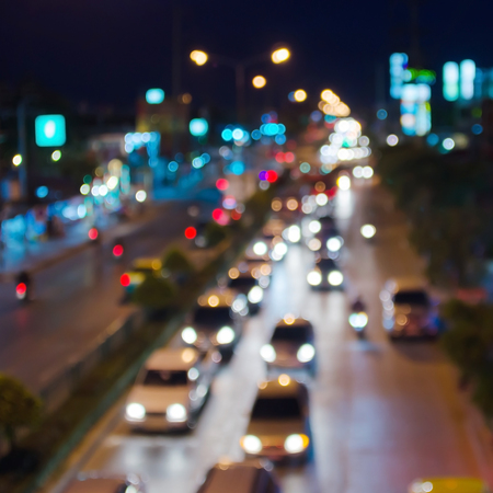 Night traffic and lights bokeh of car on road in city