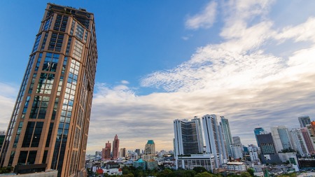 Cityscape of business building with sky and clouds in evening in Bangkok, Thailandの写真素材