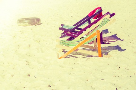 Chairs beach on sand and rubber ring in the summer vintageの写真素材