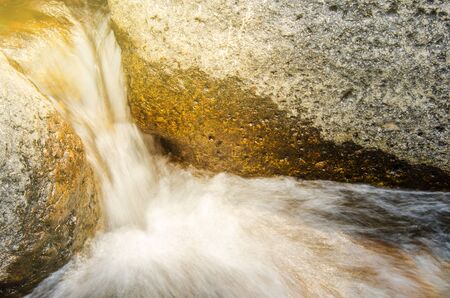 Water flowing on harden stone in the river of tropical forestの写真素材