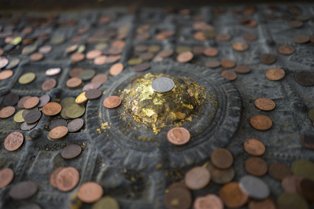 People Attach the Coins on Buddha Statue,thailandの写真素材