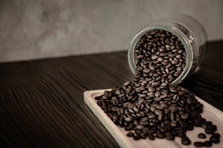 Coffee Beans Pouring Out of Jarの写真素材