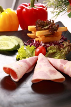 Ham, vegetables and beverages. の写真素材