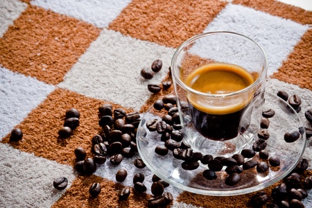 espresso coffee shot with coffee beans on fabric background.の写真素材