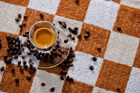 espresso coffee shot with coffee beans on fabric background.の写真素材