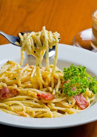 Pasta spaghetti bacon leaves on a fork. の写真素材