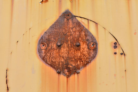 Rusty corrugated iron sheet with rivets, closeup of photoの写真素材