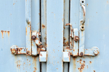 Old metal door locked with padlock, closeup of photo.の写真素材