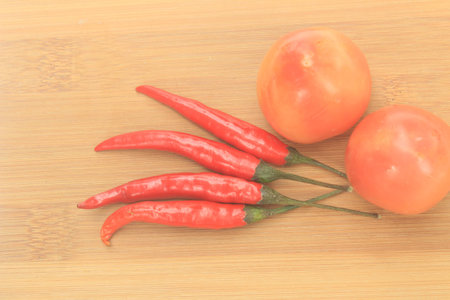 Fresh ingredients for cooking: tomato, chili on wooden backgroundの写真素材