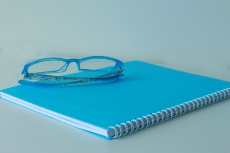 Book, blue glasses の写真素材