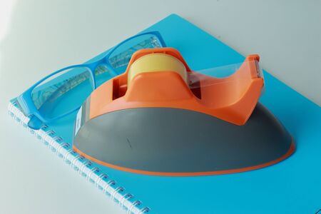 Book,sunglasses and clear adhesive tapeの写真素材