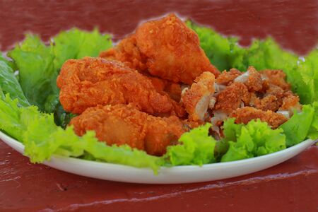 Fried chicken slices on lettuce の写真素材