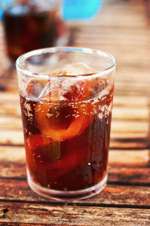 Glass of cola with ice cubesの写真素材