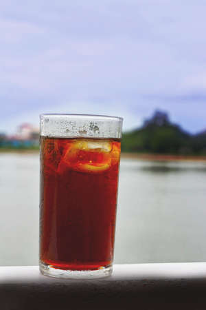 Glass of cola with ice cubesの写真素材