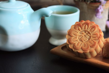 Festival moon cake and hot tea - Chinese cakeの写真素材