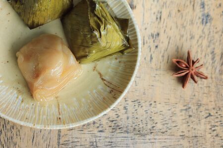 dough wrapped in banana leavesの写真素材