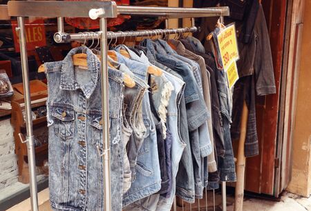 jeans clothes on hangersの写真素材