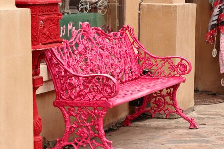 Pink chair placed in front of shopの写真素材