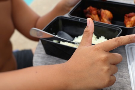 Fat boys eating chicken with riceの写真素材