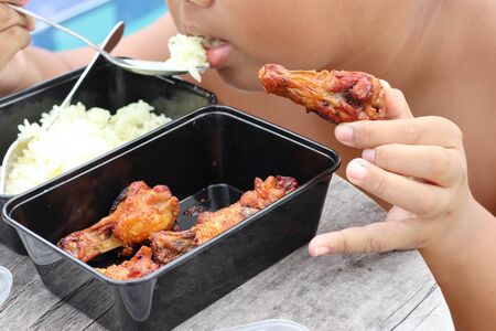 Fat boys eating chicken with riceの写真素材