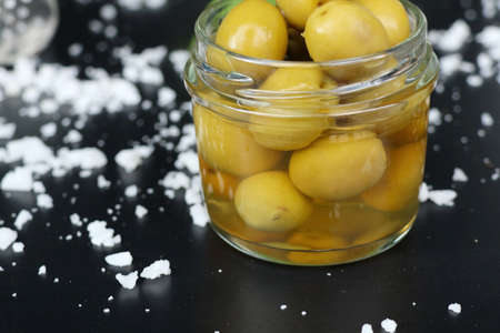 Organic green olives with saltの写真素材