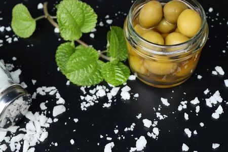 Organic green olives with saltの写真素材