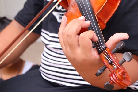 The boy play violin